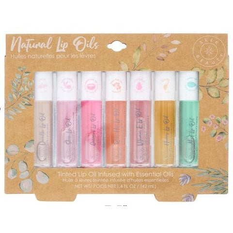 Assorted tinted lip oil set in a kraft paper package with floral accents.